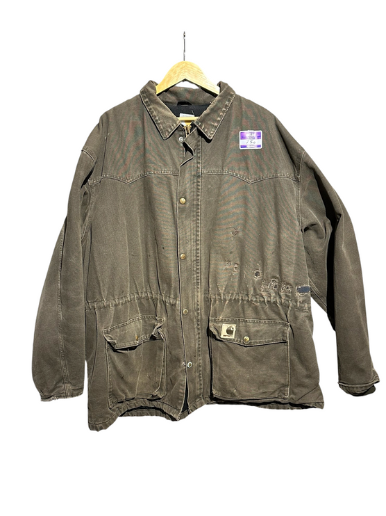 OutOf10 vintage brown Carhartt canvas field jacket with distressed patina, front pockets, and logo patch on hanger.