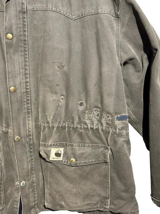 OutOf10 vintage brown Carhartt canvas field jacket with distressed wear, utility pockets, and logo patch.
