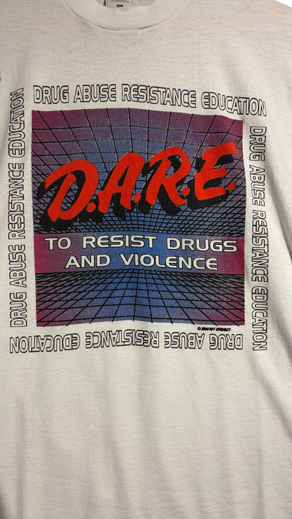 OutOf10 vintage off-white cotton t-shirt featuring a retro 90s D.A.R.E. graphic with red and blue grid design.