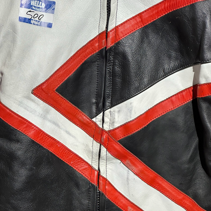 OutOf10 vintage leather motorcycle jacket featuring a bold geometric tri-colour design in white, black, and red.