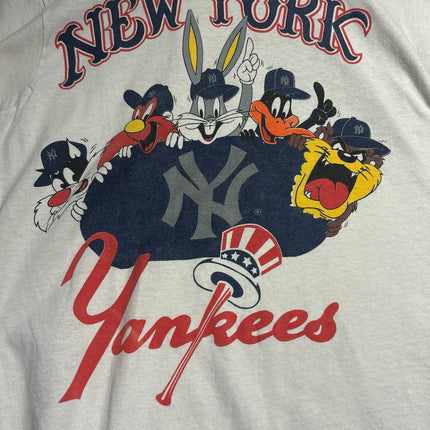 OutOf10 off-white cotton t-shirt featuring a vintage Looney Tunes and New York Yankees graphic print.