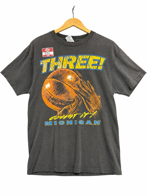 OutOf10 vintage charcoal grey Michigan basketball graphic crewneck t-shirt with Three! count it! slogan on a hanger