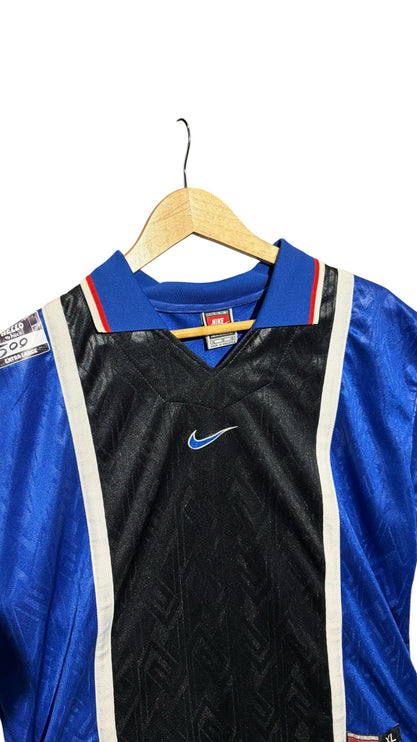 OutOf10 vintage Nike athletic jersey in royal blue and black with white piping, V-neck collar, and jacquard pattern.