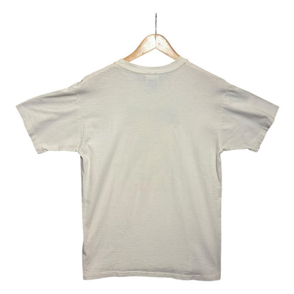 OutOf10 vintage off-white crew-neck t-shirt hanging on a wooden hanger, back view of a plain cotton tee.
