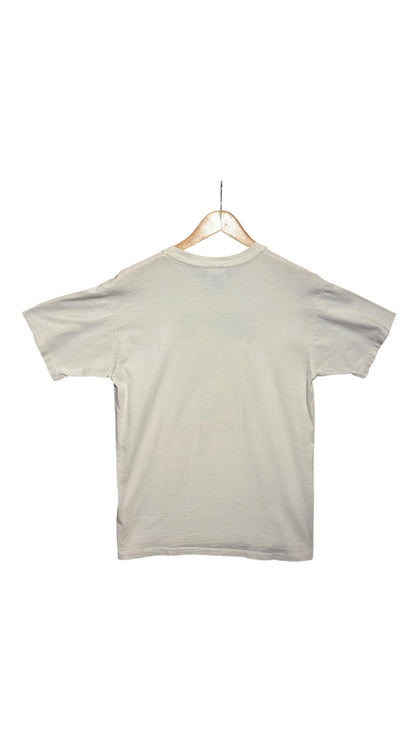 OutOf10 vintage off-white crew-neck t-shirt hanging on a wooden hanger, back view of a plain cotton tee.