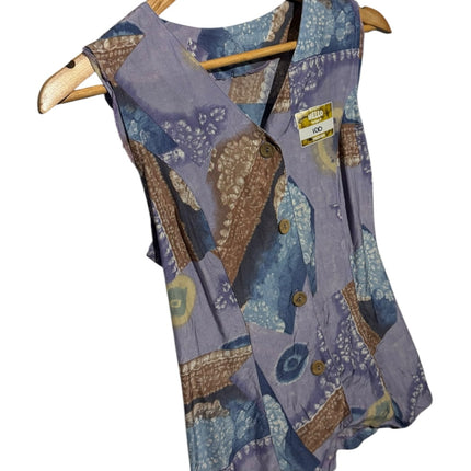 OutOf10 vintage sleeveless button-down vest with a lavender, blue, and brown patchwork print and tie-back hem detail.