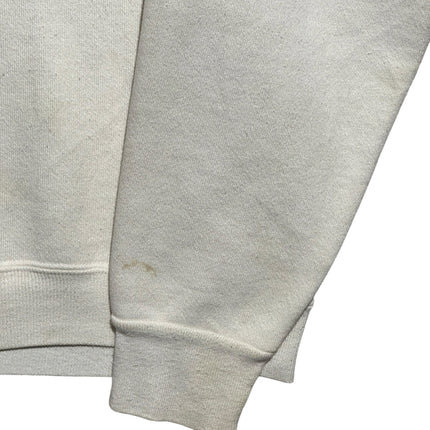 Close-up of the sleeve and cuff of an off-white OutOf10 vintage Universal Studios Florida crewneck sweatshirt