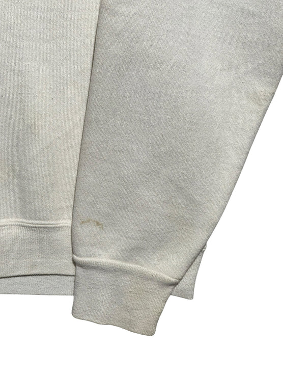 Close-up of the sleeve and cuff of an off-white OutOf10 vintage Universal Studios Florida crewneck sweatshirt