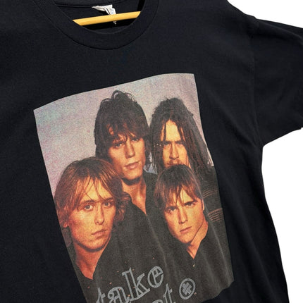 OutOf10 vintage black cotton crewneck t-shirt featuring a 1995 Take That band graphic on a wooden hanger