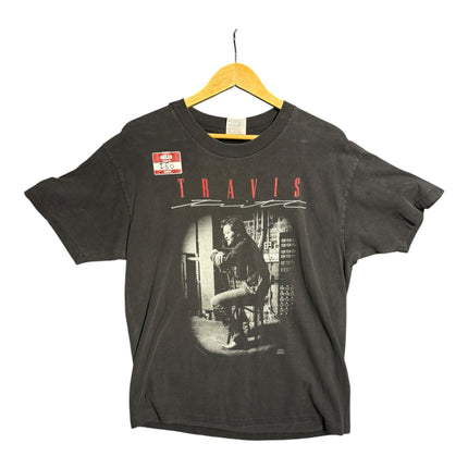 OutOf10 vintage 1993 Travis Tritt black cotton concert tour t-shirt with a front portrait graphic on a wooden hanger.