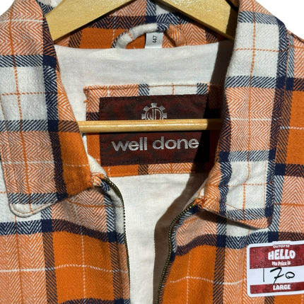 OutOf10 well done plaid zip-up jacket in orange, white, and navy blue with a classic collar on a wooden hanger.