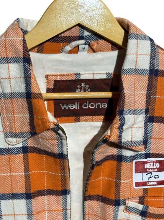 OutOf10 well done plaid zip-up jacket in orange, white, and navy blue with a classic collar on a wooden hanger.