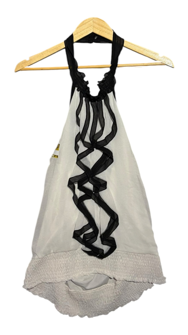OutOf10 white sleeveless halter neck blouse with black ruffled trim and a shirred elastic hem on a wooden hanger.
