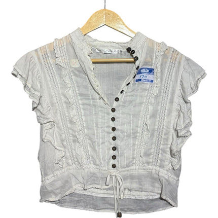 OutOf10 white vintage-style blouse with ruffled shoulders, lace trim, and a button-down front with dark buttons.