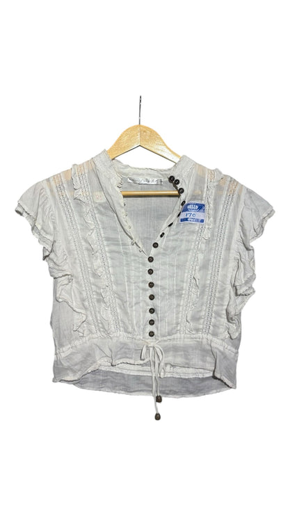OutOf10 white vintage-style blouse with ruffled shoulders, lace trim, and a button-down front with dark buttons.